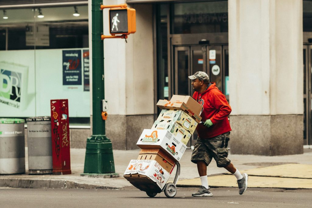 a man pushing a cart full of boxes