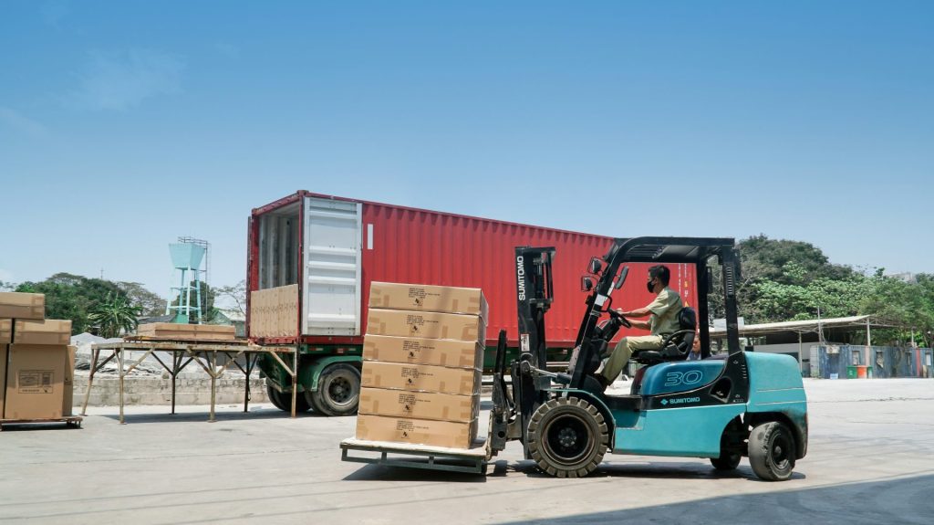 blue and black utility truck on gray concrete road during daytime